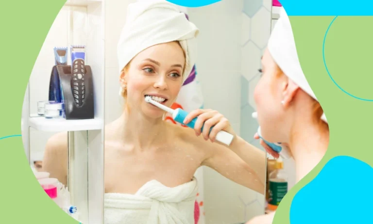 Woman brushing teeth with an electric toothbrush in a modern bathroom.Woman brushing teeth with an electric toothbrush in a modern bathroom.Woman brushing teeth with an electric toothbrush in a modern bathroom.